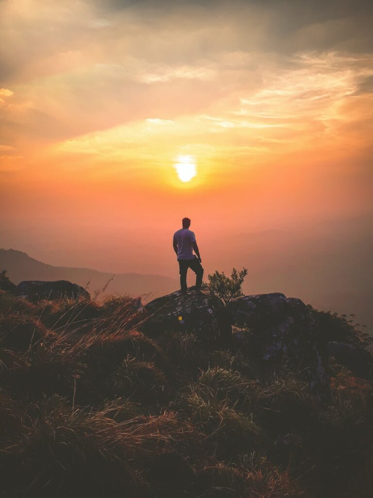 He standing on rock during sunset
